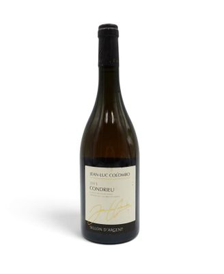 a bottle of white wine sitting on top of a white table