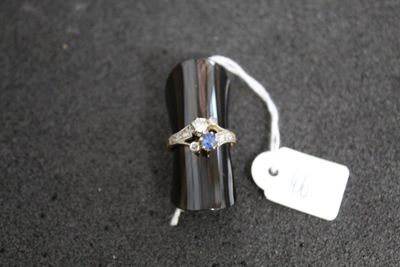 a silver ring with a blue stone on top of it
