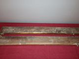 two pieces of wood sitting on top of a red cloth