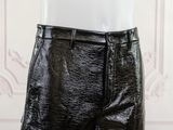 a close up of a mannequin torso wearing black leather shorts