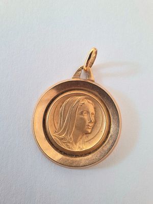 a close up of a gold coin with a woman ' s face on it