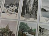 many postcards with asian writing on them on a table
