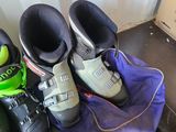 several pairs of ski boots are lined up on the floor