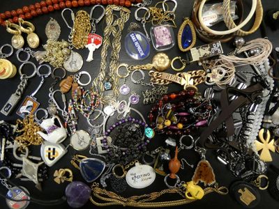 many different types of necklaces on a black table