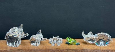 several figurines of elephants and other animals on a wooden table