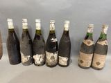 several bottles of wine are lined up on a table
