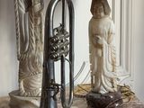 a table with a lamp and a trumpet on it
