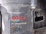 a close up of a bosch drill on a table
