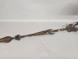 a metal object that is laying on a white surface