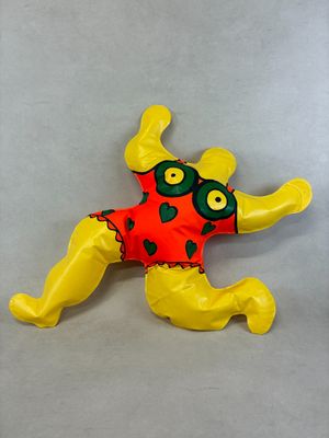 a stuffed frog that is laying down on the floor