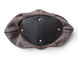 a black and brown purse with gold buttons on it