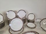 a lot of plates and bowls that are on the table