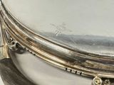 a close up of a silver plate with a knife and fork