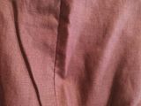 the back of a pink dress with a black tie on it