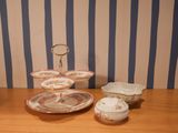 a wooden table topped with plates and bowls on top of it
