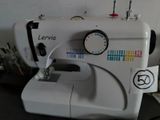 a white sewing machine sitting on top of a table