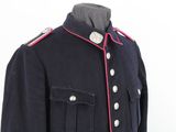an image of a blue military jacket with pink pips on the collar