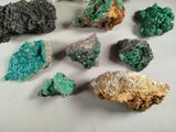 several different types of rocks and crystals on a white surface