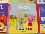 several children ' s books are lined up on a table