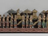 a wooden sculpture of a group of people on a boat