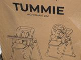 cardboard box with instructions for a child ' s high chair in a store