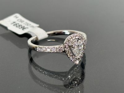 a close up of a diamond ring on a black surface