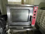 a small oven sitting on a table in a room