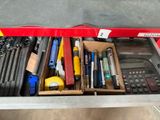 a drawer full of tools in a store with a calculator and a calculator