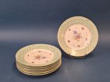 several plates are stacked on top of each other on a blue surface