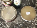 three jars sitting on a marble table with a label on them