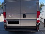 a silver van that is parked in a parking lot