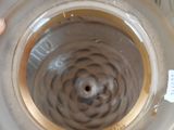 a person holding a vase that has a hole in it