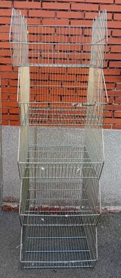 two cages that are next to each other on the sidewalk