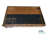 a cardboard box with a sign on it that says uhd tv