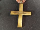 a cross on a table with a chain around it