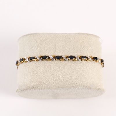 un gros plan sur un bracelet orné de pierres noires et blanches