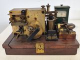a small machine that is sitting on top of a wooden box