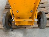 a yellow machine that is sitting on top of a pallet