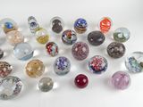 a lot of glass marbles on a white surface
