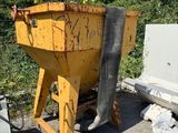 a yellow dumpster sitting next to a blue hose