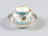 tea cup and saucer decorated with flowers on a white background