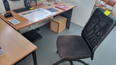 a desk with a chair and a computer on it
