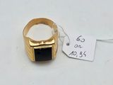 a gold ring with a black stone on it and a price tag