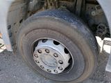 a flat tire on a flatbed truck parked on the side of the road