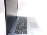 a laptop computer that is sitting on a white surface