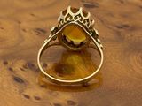 an image of a gold ring with a citrine stone in the center