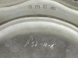 a close up of a silver plate with writing on it