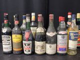 many bottles of alcohol lined up on a table
