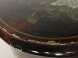 a close up of a wooden table with a painted top