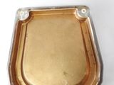 a small metal box with a gold lid on a white surface